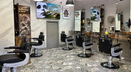 Sleek interior of Broadway Barbershop, Ultimo, NSW, AU, featuring modern black styling chairs and artistic decor.