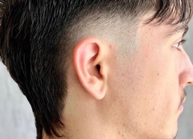 Fresh fade hairstyle at Highland Hair Salon, Melbourne, Victoria, AU, showcasing modern grooming style.