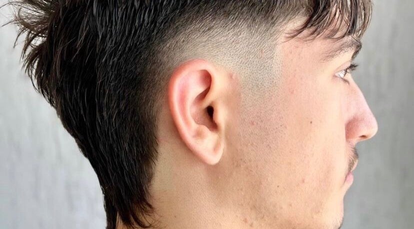 Fresh fade hairstyle at Highland Hair Salon, Melbourne, Victoria, AU, showcasing modern grooming style.