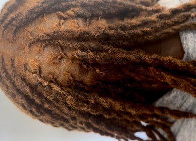 Beautiful brown locs styled at Locced by Ny in Coventry, England, GB. Perfect blend of style and care.