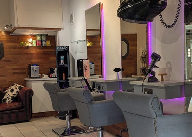 Modern styling chairs at Hair Workshop in Maidstone, England, GB, with chic interiors and relaxing ambiance.