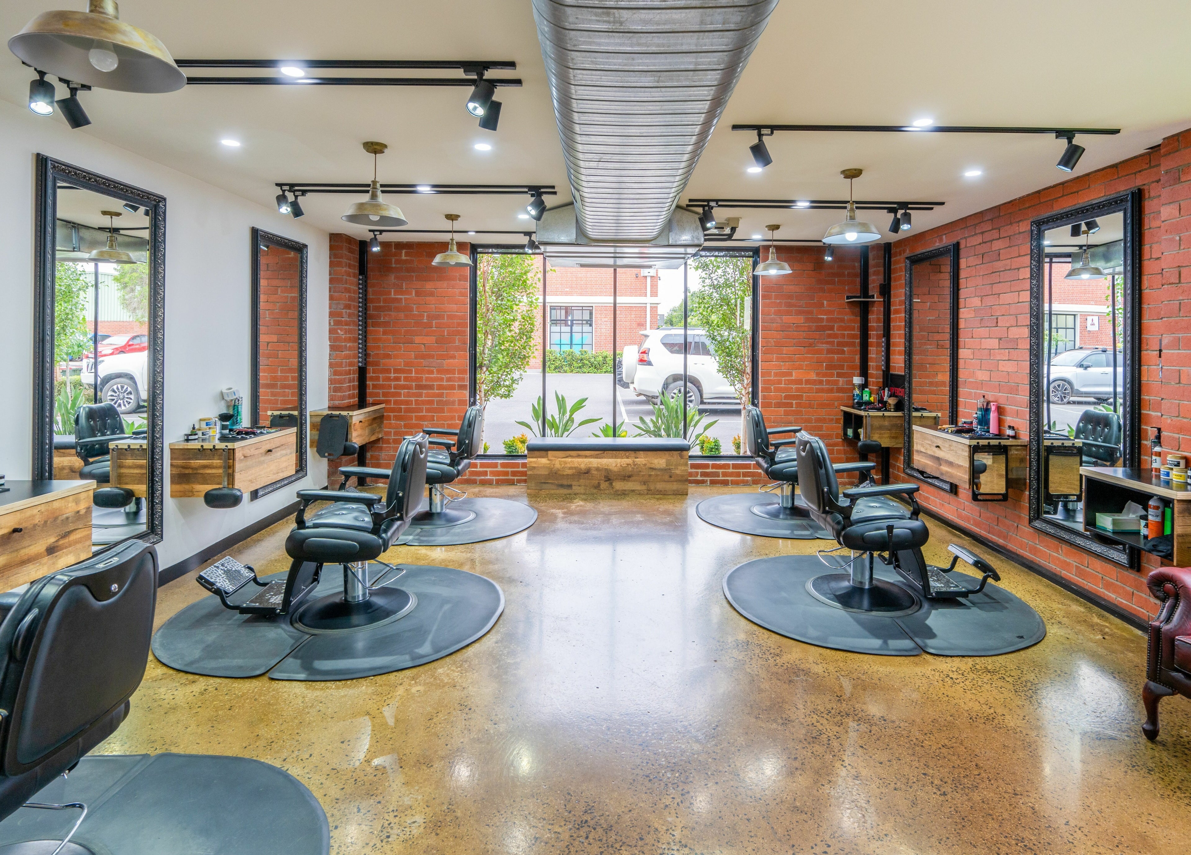 Spacious interior of Rex and Ross Barber - Newtown, showcasing stylish barber chairs, Newtown, Victoria, AU.