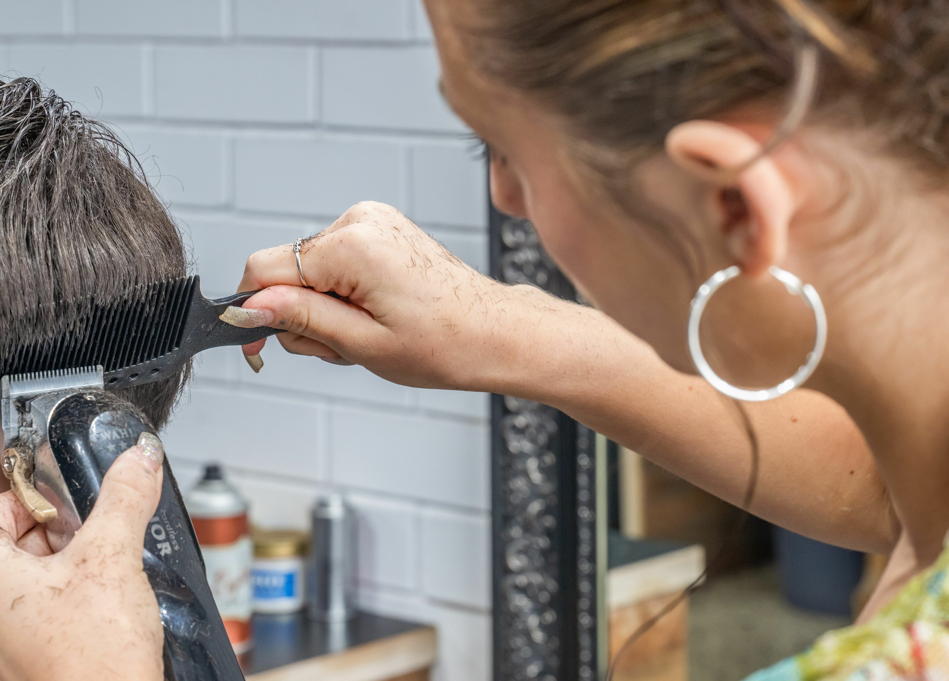 Stylist using clippers at Rex and Ross Barber - Geelong West, Geelong West, Victoria, AU.