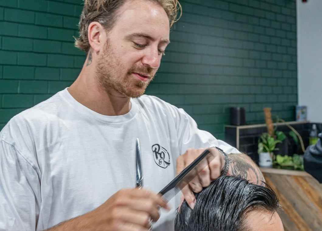 Barber at Rex and Ross Barber - Geelong West styling hair at Geelong West, Victoria, AU.