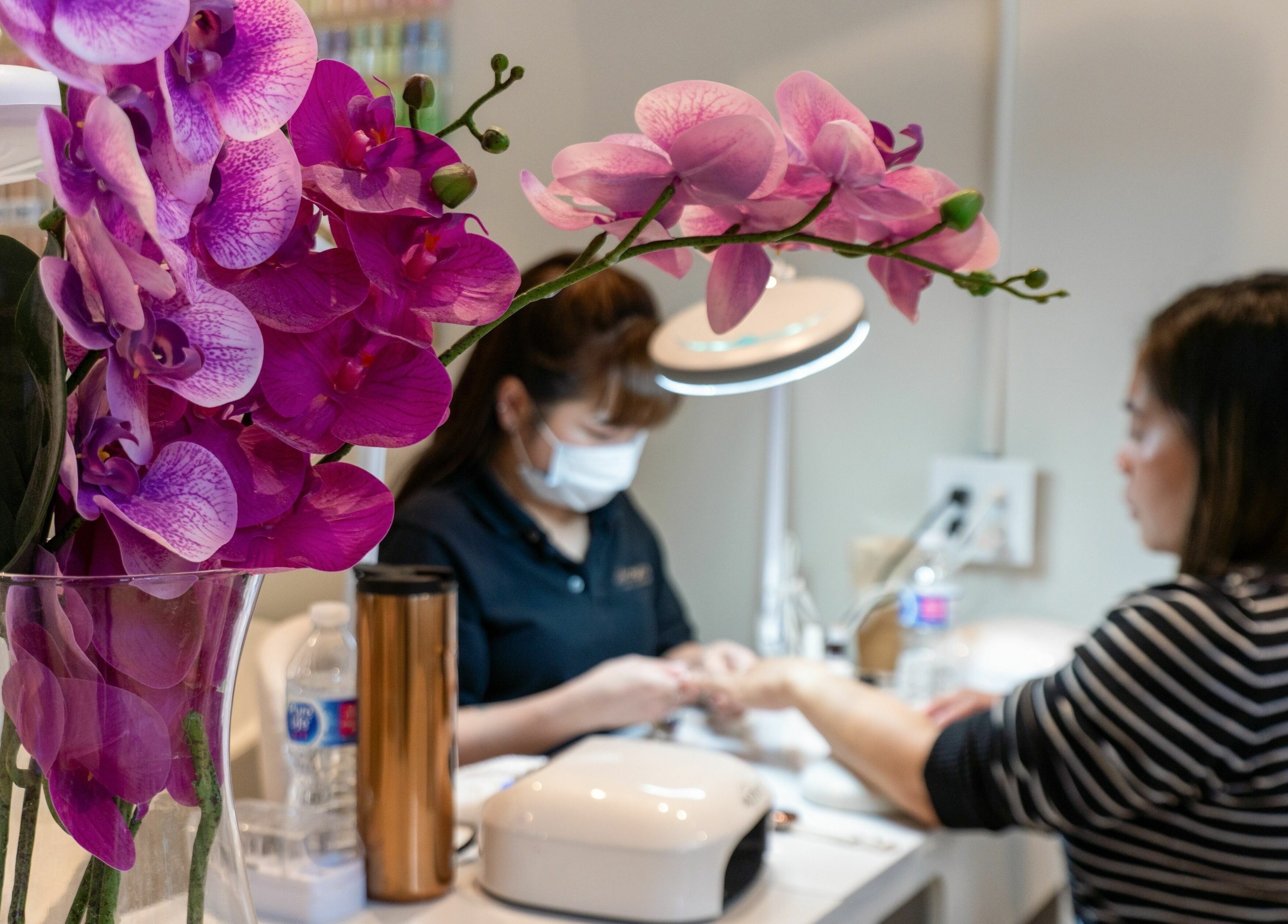 Orchids at Champagne Nail Lounge at the Quay, New Westminster, British Columbia, CA, enhancing client manicure experience.