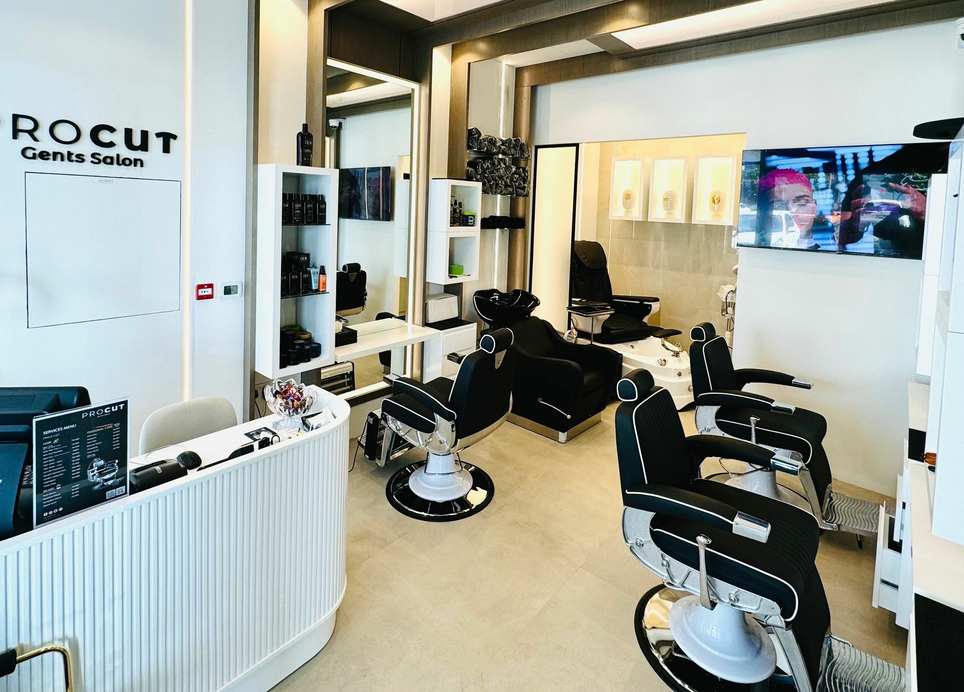 Modern interior of Procut Gents Salon in دبي, دبي, AE featuring sleek barber chairs and a minimalist desk.