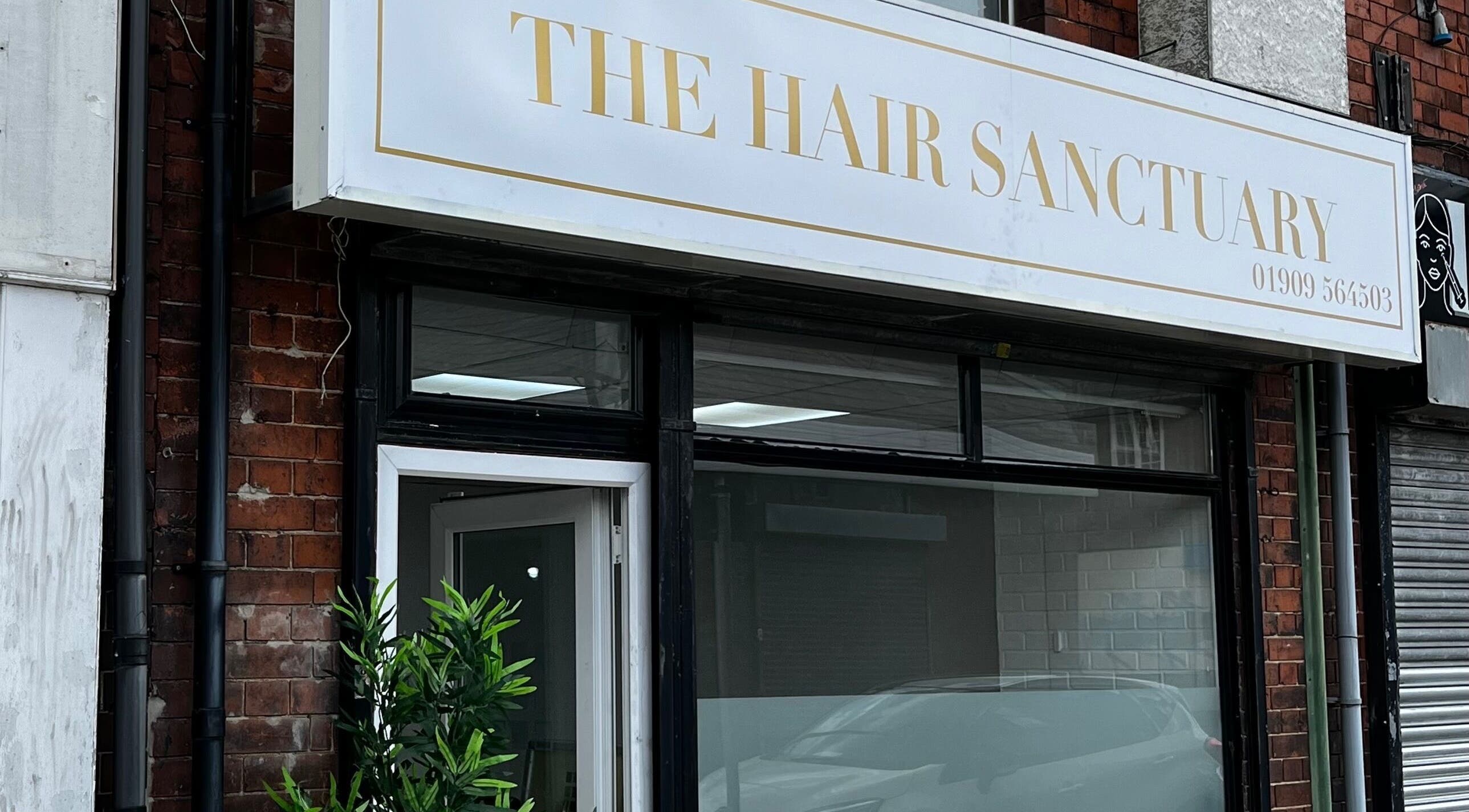 Front view of The Hair Sanctuary, Dinnington salon in England, GB with stylish signage.