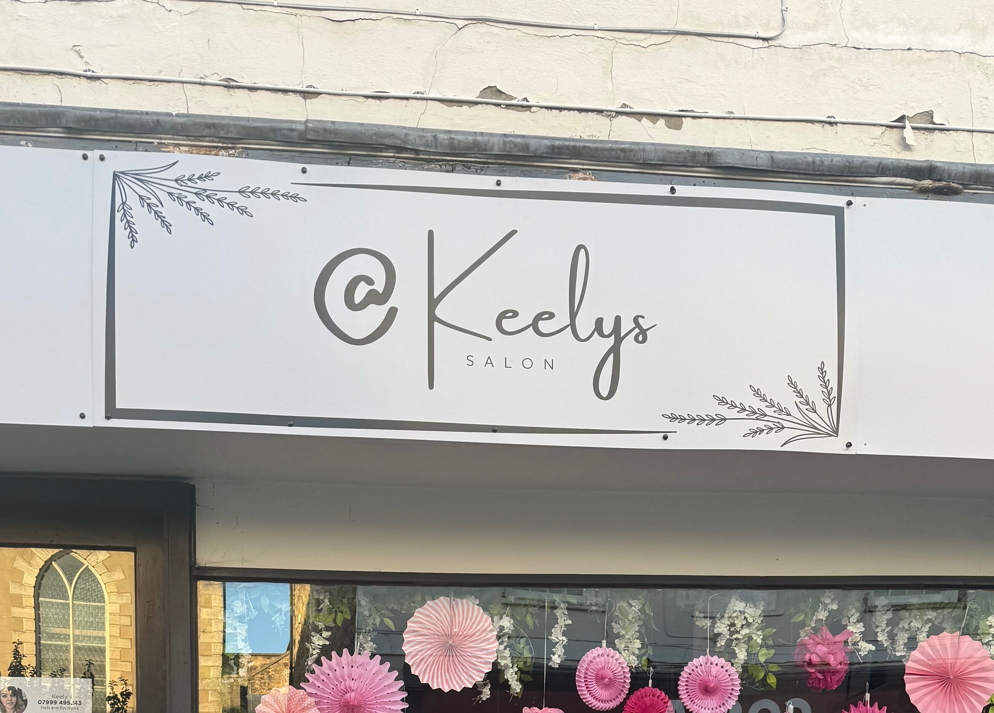 Front view of Keelys salon in Faringdon, England, GB showcasing elegant signage with decorative elements.