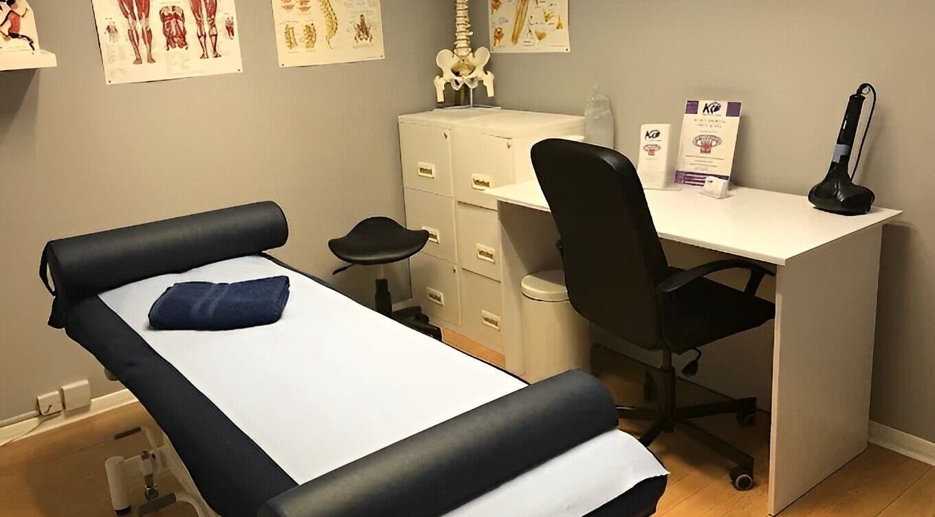 Spacious therapy room at Basildon - Club Kingswood, Basildon, Essex, GB with a massage table and anatomical charts.