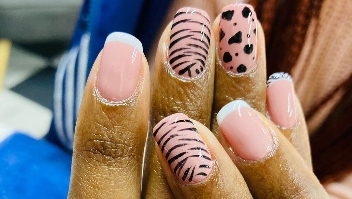 Stylish nail art design at Zamabongwe Nails in Cape Town, Western Cape, ZA with pink and black patterns.
