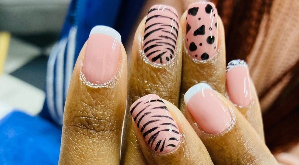Stylish nail art design at Zamabongwe Nails in Cape Town, Western Cape, ZA with pink and black patterns.