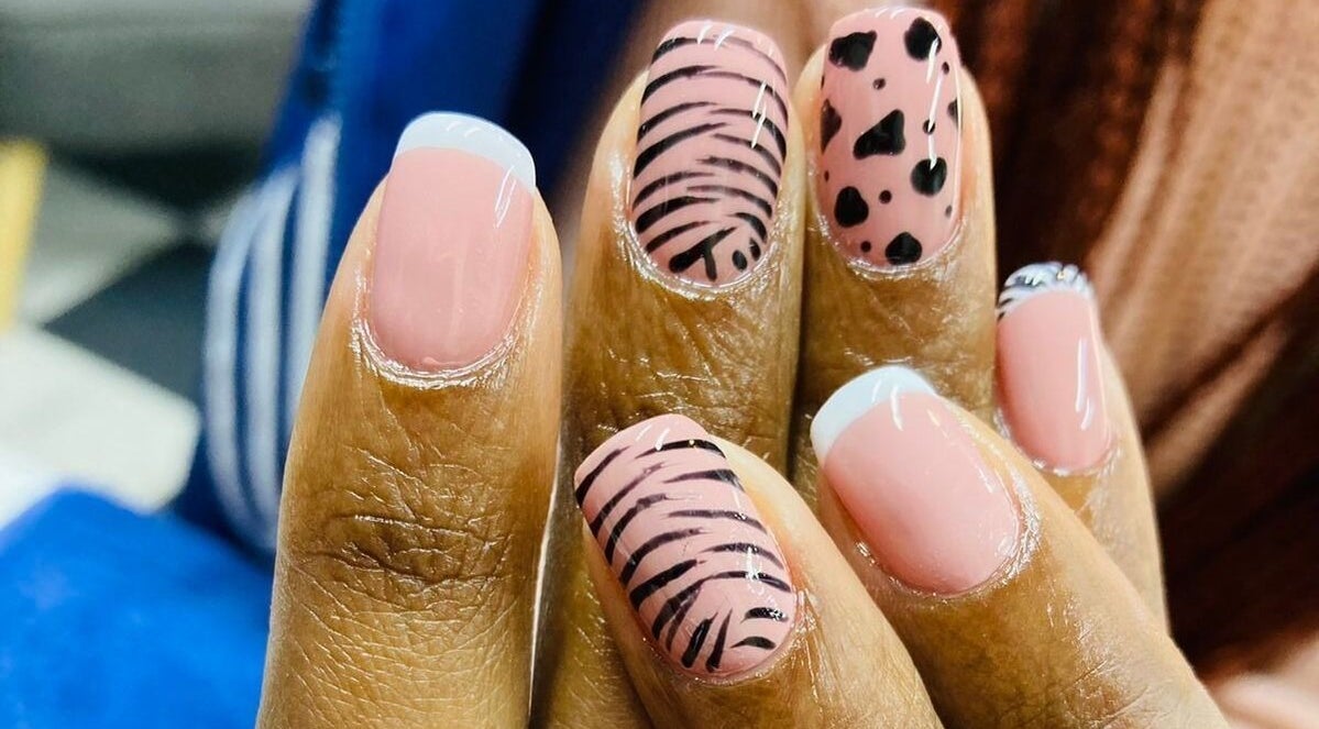 Stylish nail art design at Zamabongwe Nails in Cape Town, Western Cape, ZA with pink and black patterns.