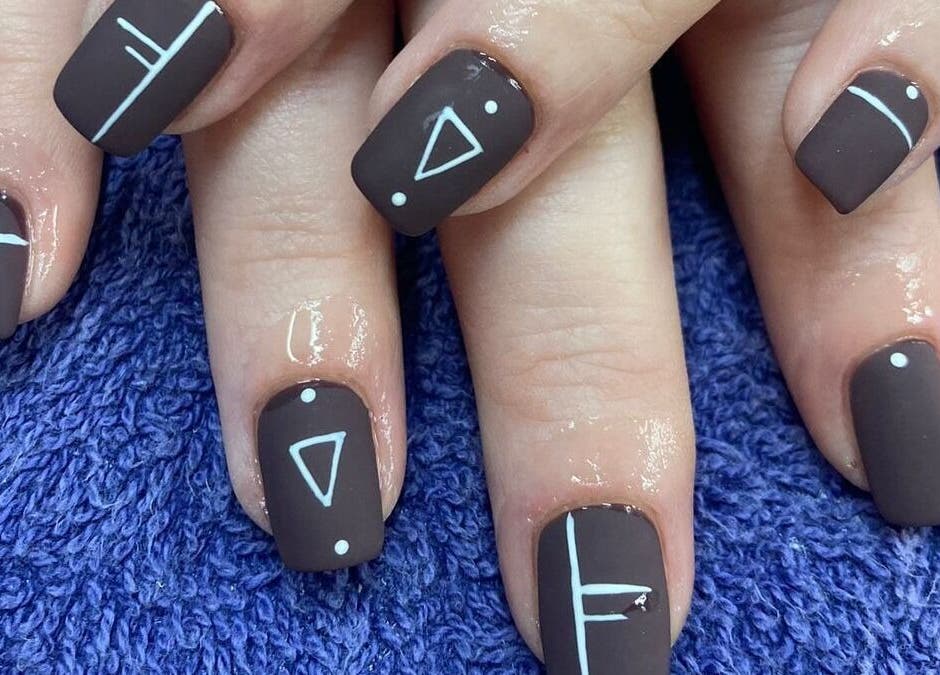 Brown nails with geometric designs at Zamabongwe Nails, Cape Town, Western Cape, ZA.