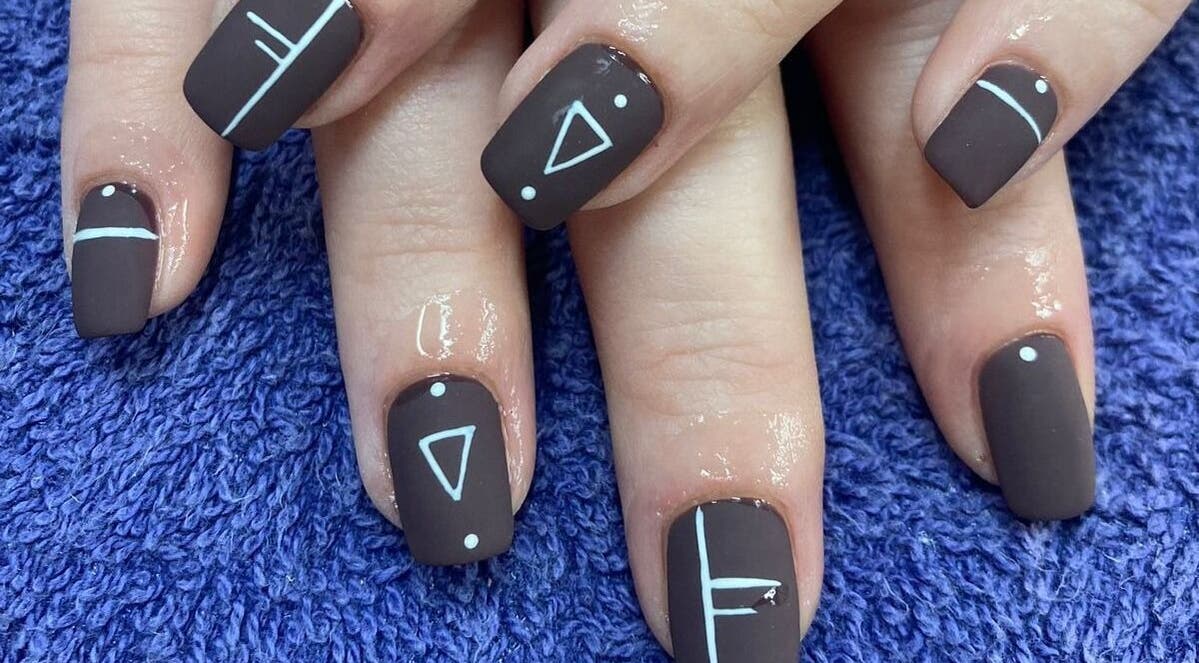 Brown nails with geometric designs at Zamabongwe Nails, Cape Town, Western Cape, ZA.