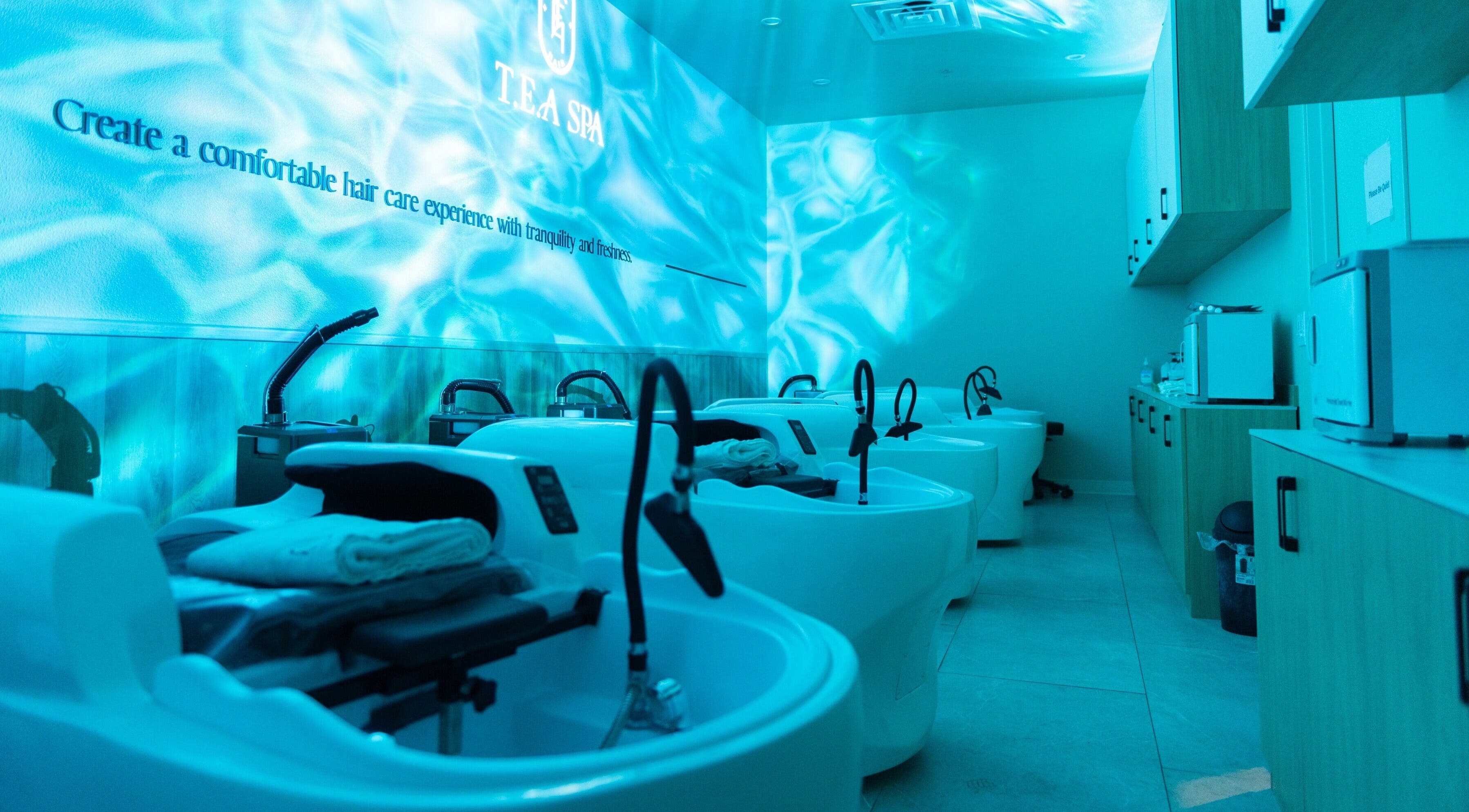 Relaxing wash station at Tea Scalp & Hair Spa, Las Vegas, Nevada, US with aqua lighting for tranquility.
