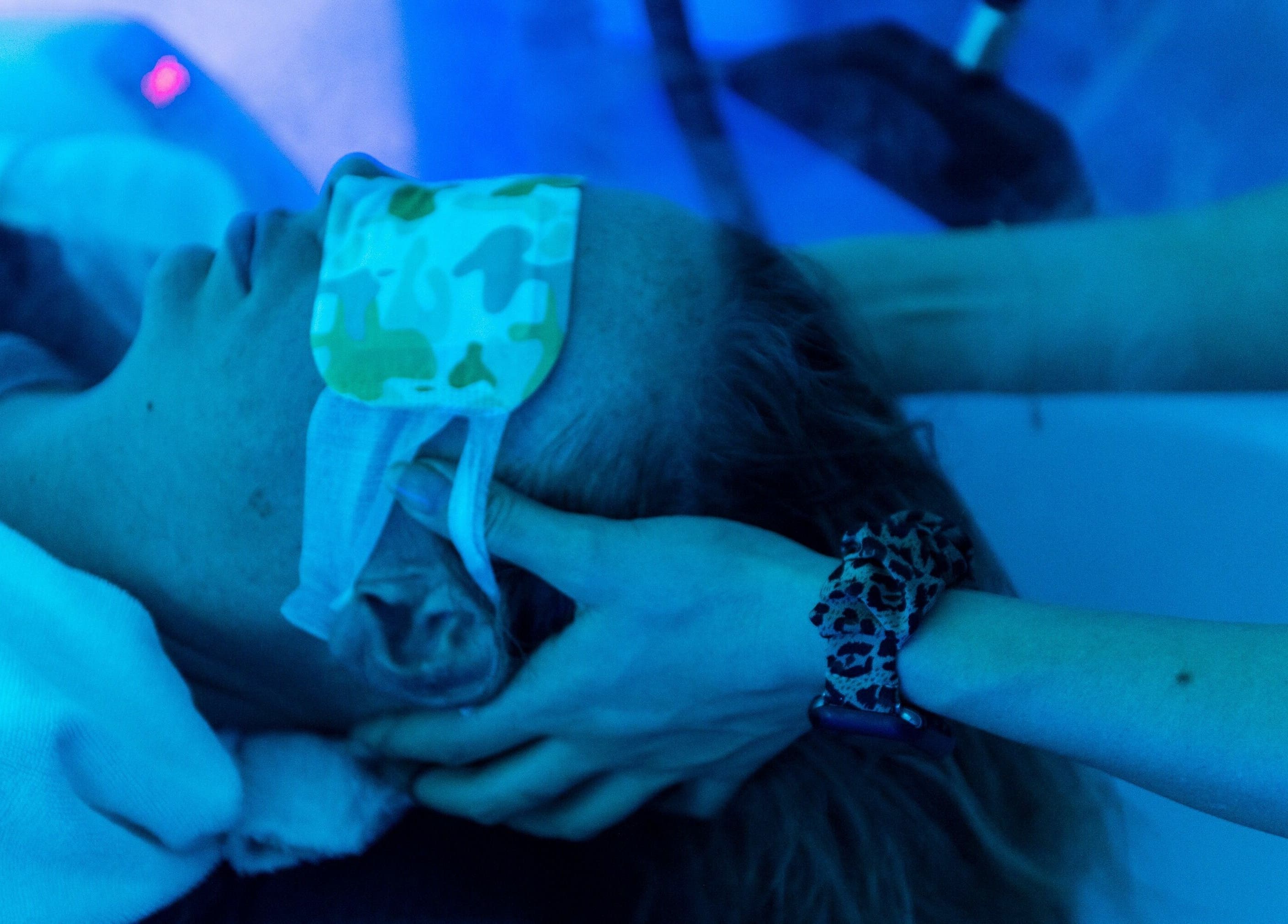 Serene head massage at Tea Scalp & Hair Spa in Las Vegas, Nevada, US under calming blue light.