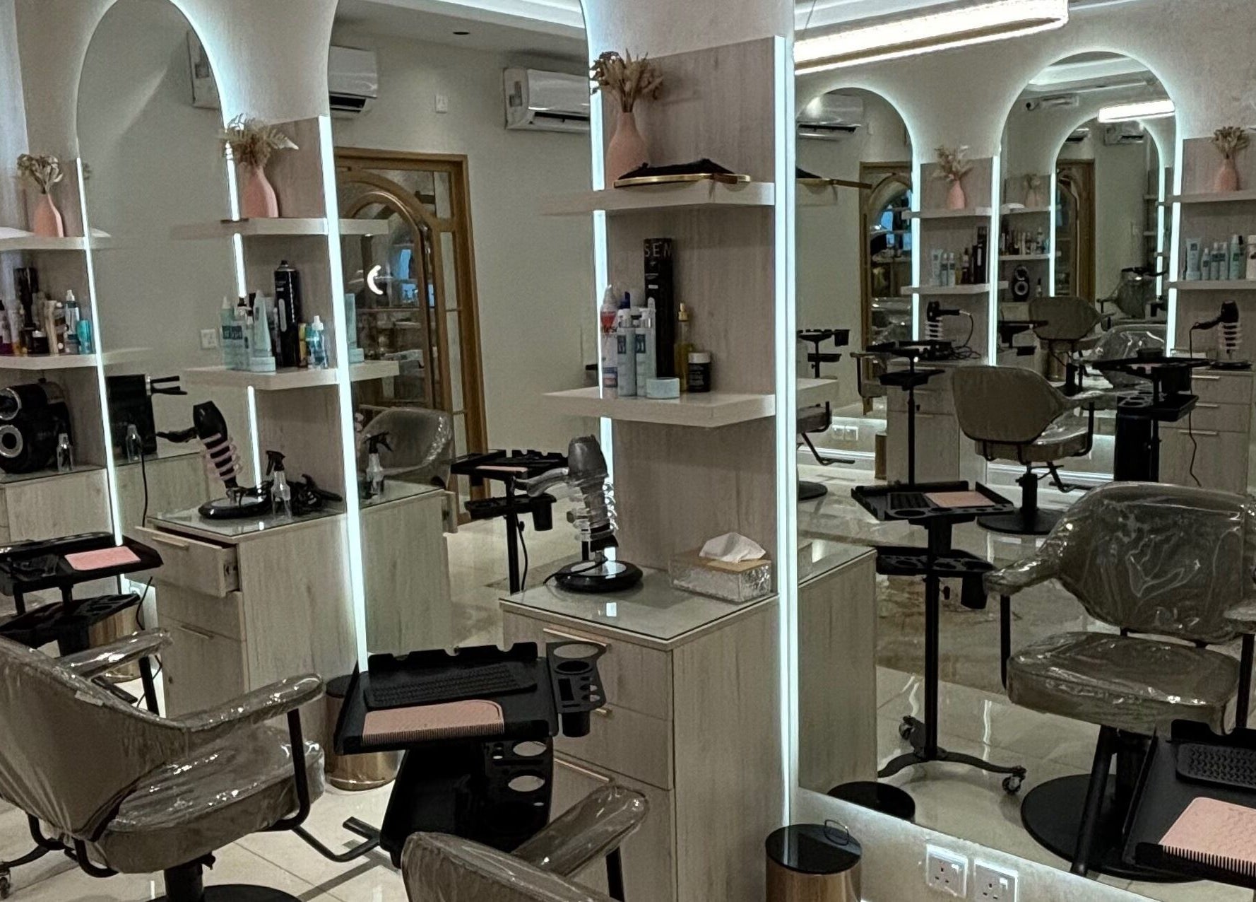 Sophisticated salon interior at Wafaa Altamayoz, Jeddah, Makkah Province, SA showcasing modern styling stations.