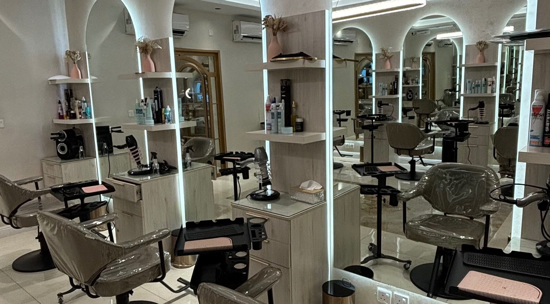 Sophisticated salon interior at Wafaa Altamayoz, Jeddah, Makkah Province, SA showcasing modern styling stations.
