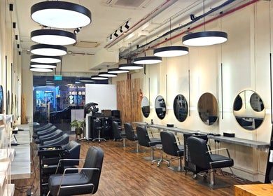 Chic salon interior at Philosophy Studio in Singapore, SG, featuring modern chairs and stylish decor.