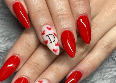 Red manicured nails with heart design by Azalea Beauty Spa, Tzaneen, Limpopo, ZA.