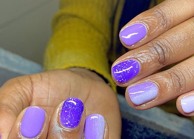 Vibrant purple manicure at Azalea Beauty Spa in Tzaneen, Limpopo, ZA. Glittery finish showcases expert nail art.