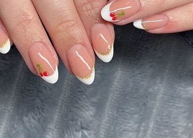 Stylish French manicure with cherry art at Azalea Beauty Spa, Tzaneen, Limpopo, ZA.