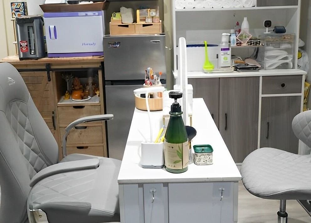 Modern manicure station at Glam E Nails in Arlington, Virginia, US, featuring stylish grey seating.