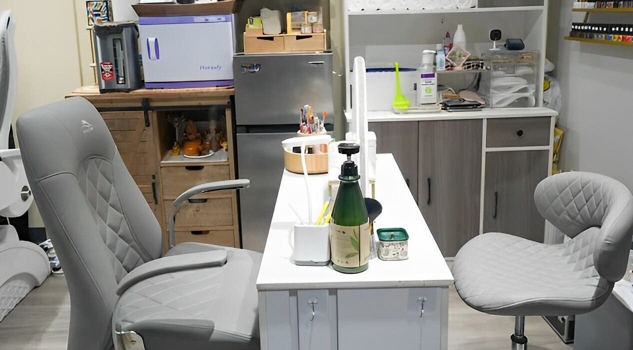 Modern manicure station at Glam E Nails in Arlington, Virginia, US, featuring stylish grey seating.