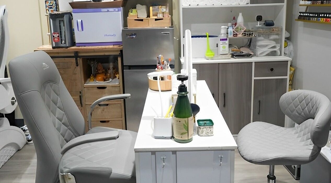 Modern manicure station at Glam E Nails in Arlington, Virginia, US, featuring stylish grey seating.