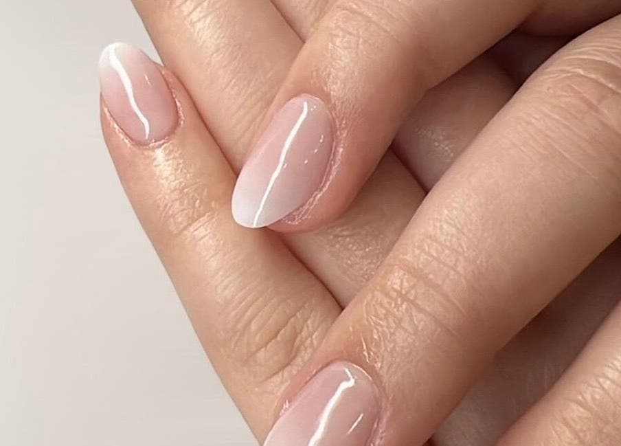 Close-up of elegant pink manicure at Glam E Nails, Arlington, Virginia, US promoting beauty and nail care.