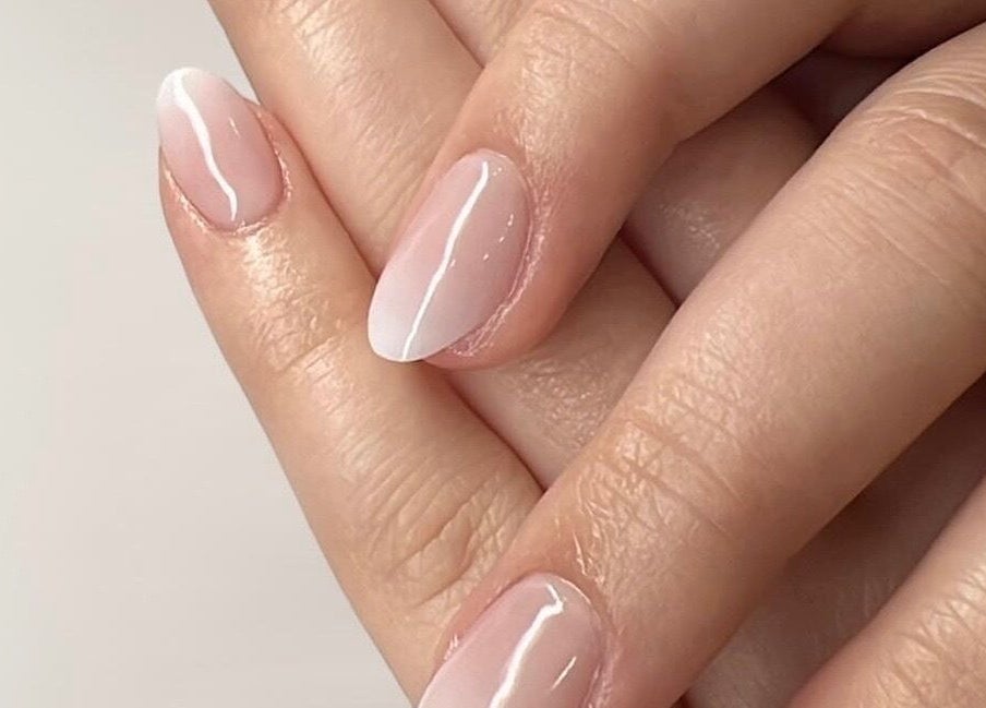 Close-up of elegant pink manicure at Glam E Nails, Arlington, Virginia, US promoting beauty and nail care.