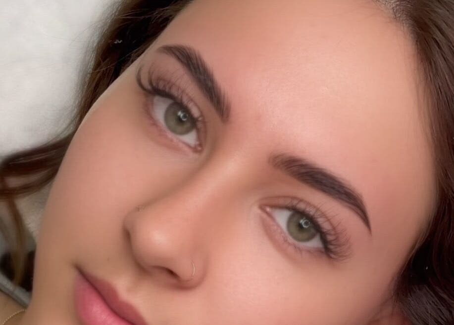 Close-up of a woman's face with perfectly shaped brows at Liquid Gold Studio, Winnipeg, Manitoba, CA.