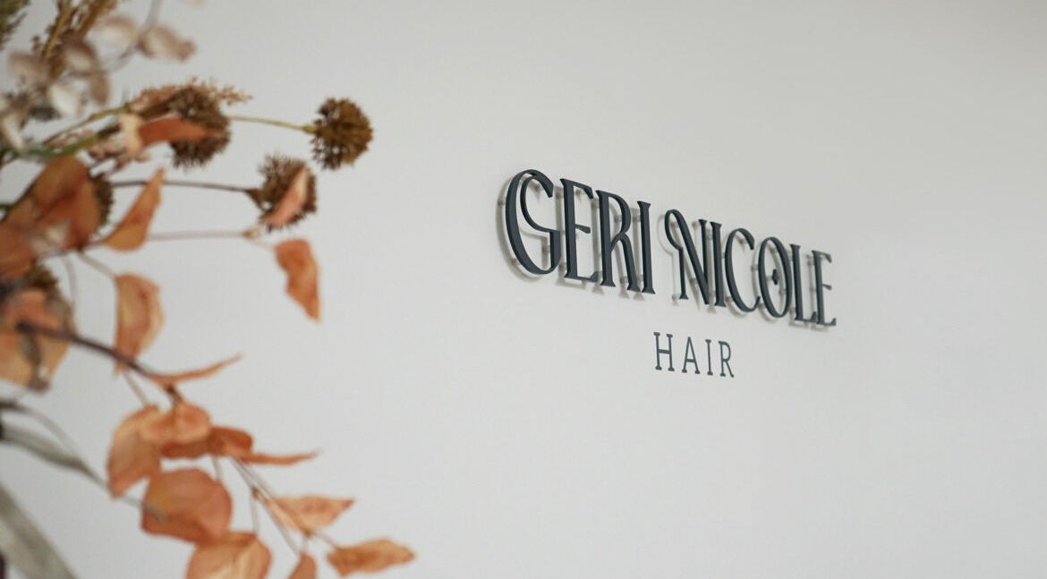 Signage of Geri Nicole Hair at Blackburn, England, GB with decorative dried plants.