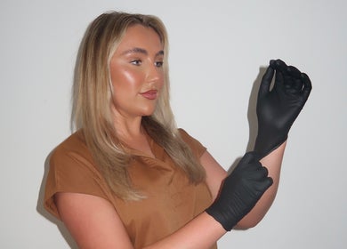 Beautician at Cosmetics By Chlo, Westhoughton, England, wearing gloves for a treatment session.