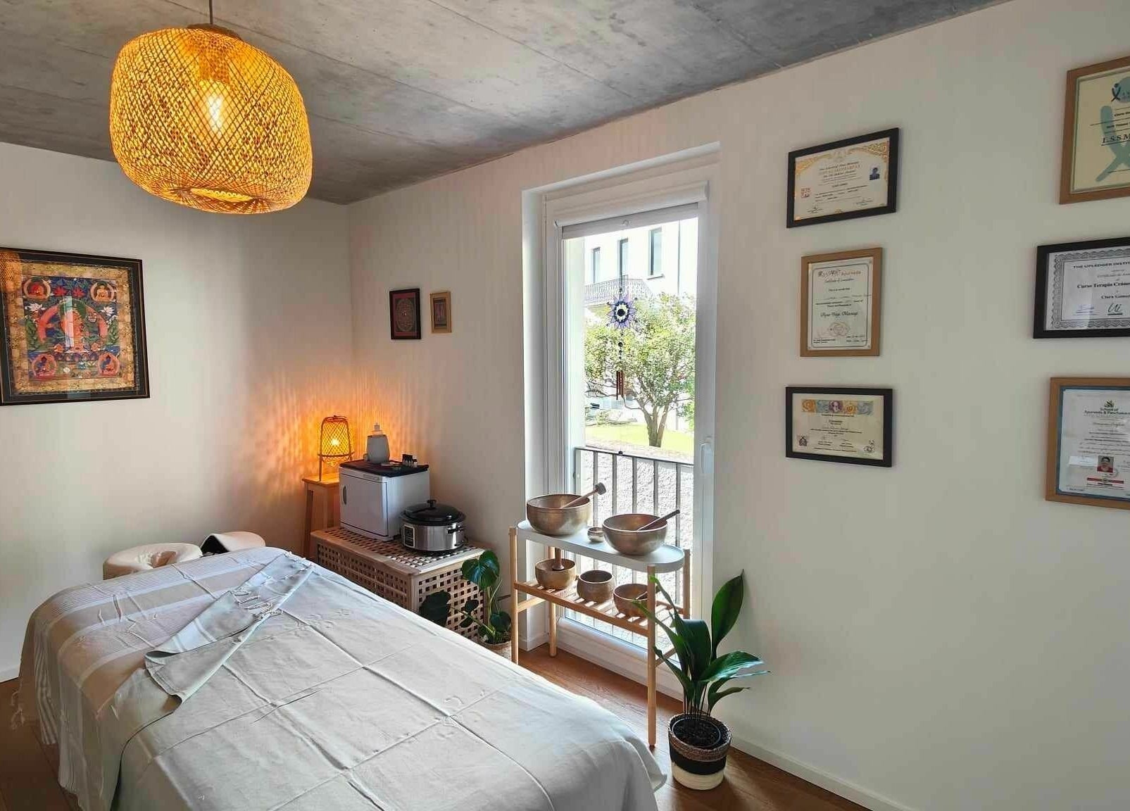 Relaxing massage room at Studio Mudita Locarno with certifications and warm lighting, Locarno, Ticino, CH.