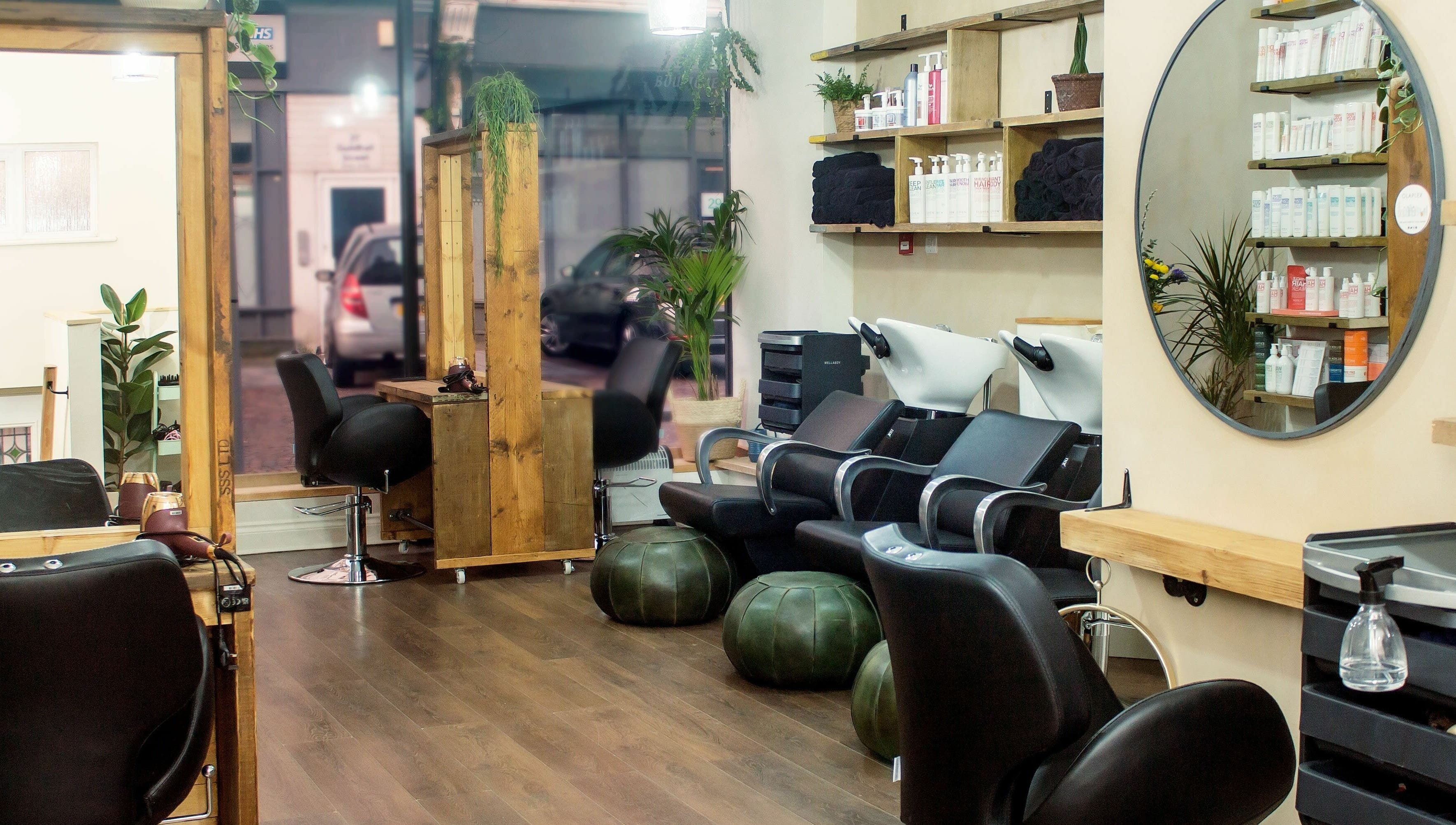 Stylish interior of The Workhouse Hair salon in Folkestone, England, GB featuring modern seating and decor.