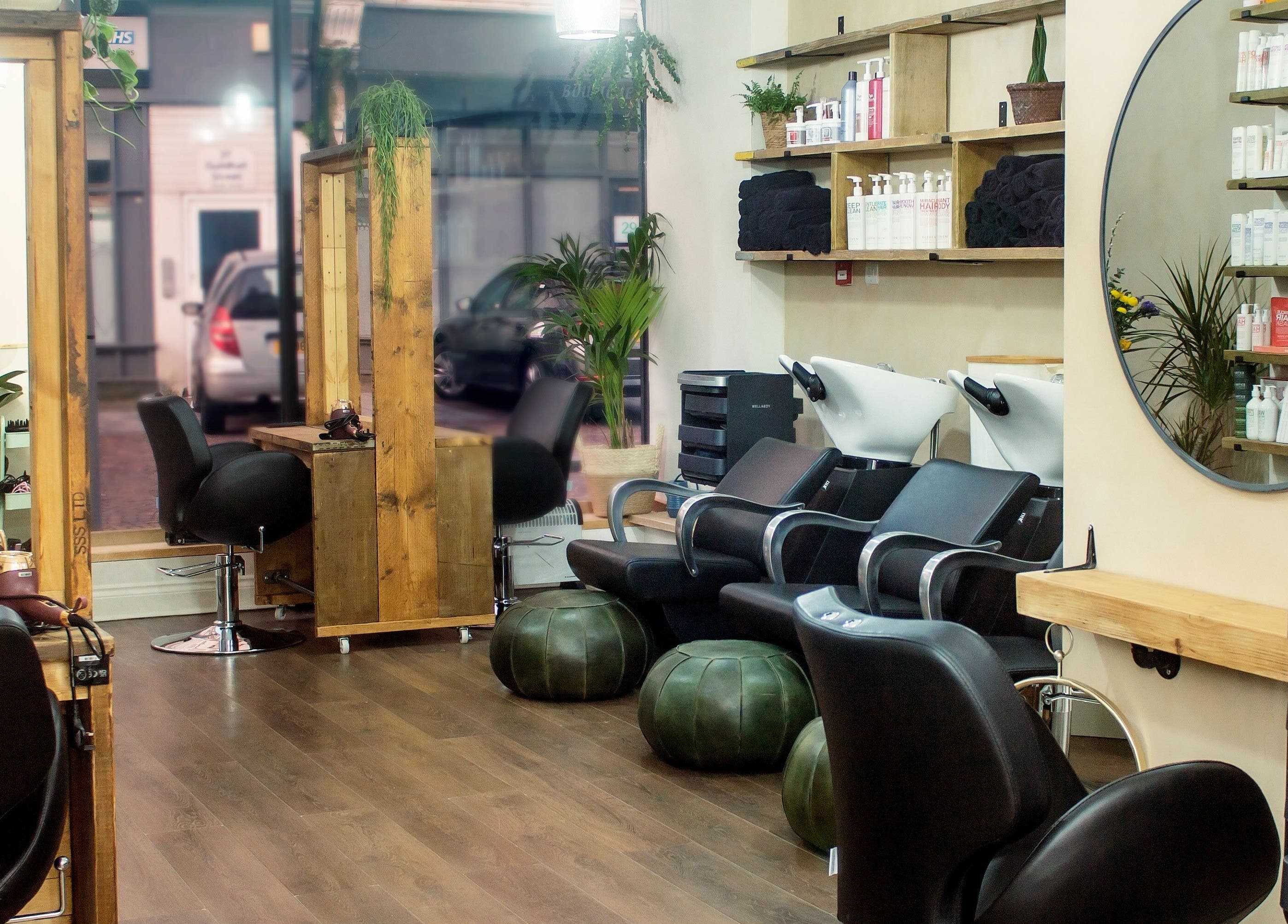 Stylish interior of The Workhouse Hair salon in Folkestone, England, GB featuring modern seating and decor.