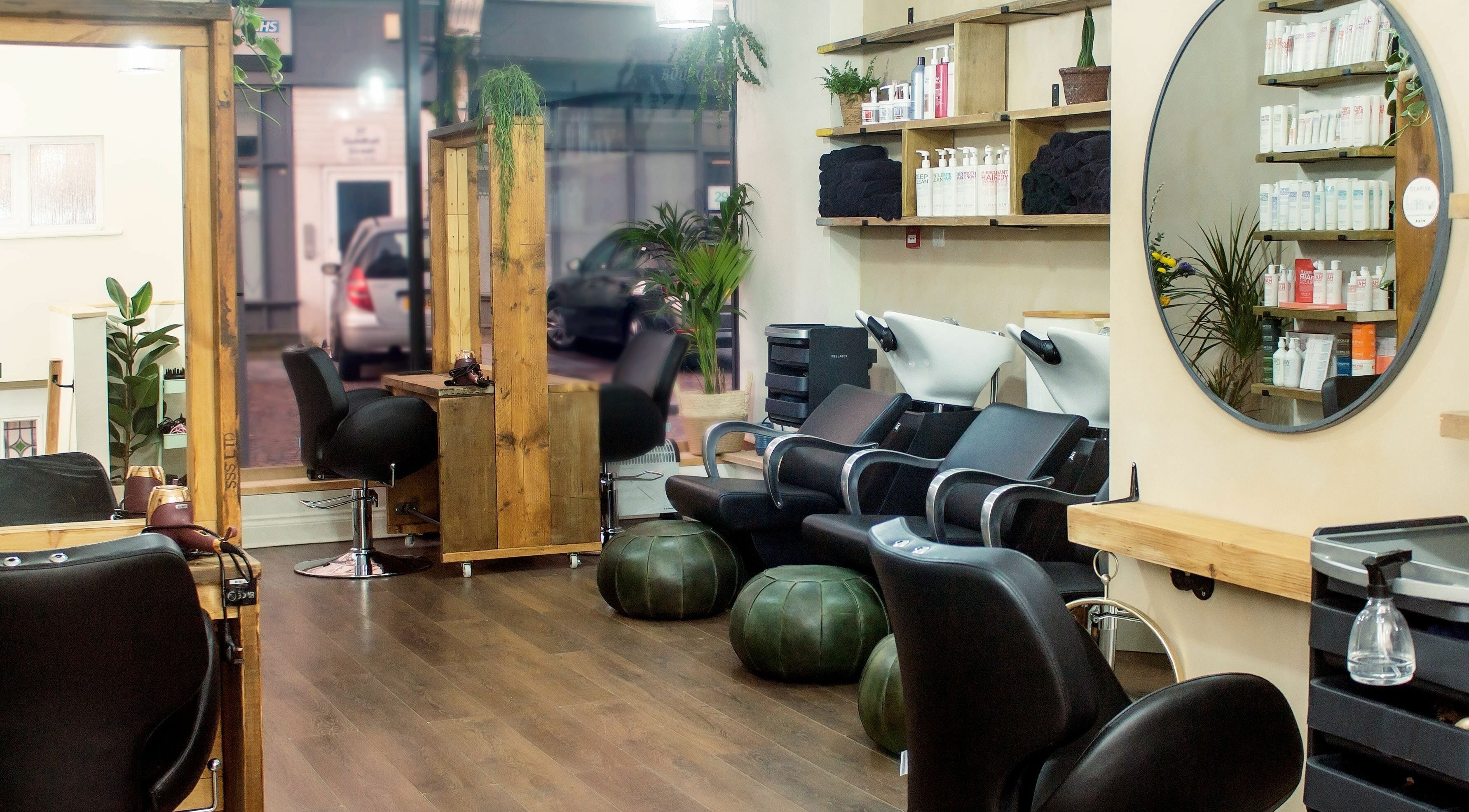 Stylish interior of The Workhouse Hair salon in Folkestone, England, GB featuring modern seating and decor.