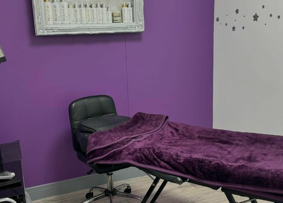 Relaxing treatment room at Mirror Mirror, Aylesford, England, GB with plush purple decor and tranquil ambiance.