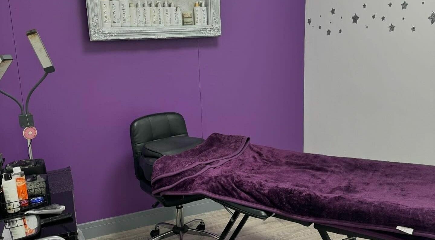 Relaxing treatment room at Mirror Mirror, Aylesford, England, GB with plush purple decor and tranquil ambiance.