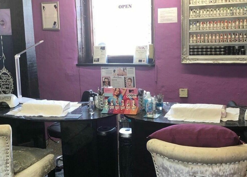 Nail care station at Mirror Mirror, Aylesford, England, GB with plush seating and vibrant decor.