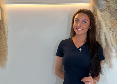 Woman standing at The Beaute HQ, Melton Mowbray, England, adorned with natural decor accents.