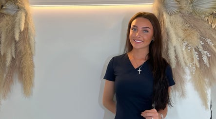 Woman standing at The Beaute HQ, Melton Mowbray, England, adorned with natural decor accents.