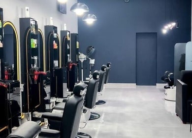 Sleek interior of Barb Bros salon in Dubai, Dubai, AE, featuring modern styling chairs and equipment.