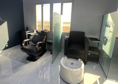 Sleek styling stations at Barb Bros, Dubai, Dubai, AE, showcasing modern barber and pedicure chairs.