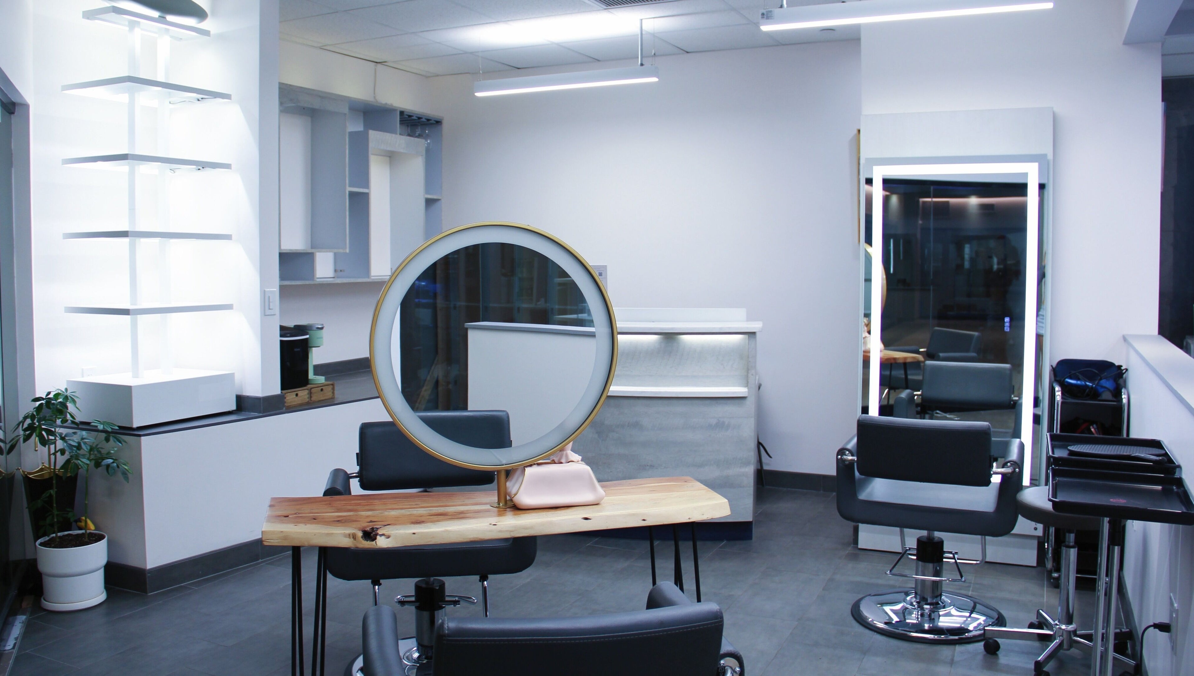 Modern salon interior with round mirror at Nova Salon in New York, New York, US.