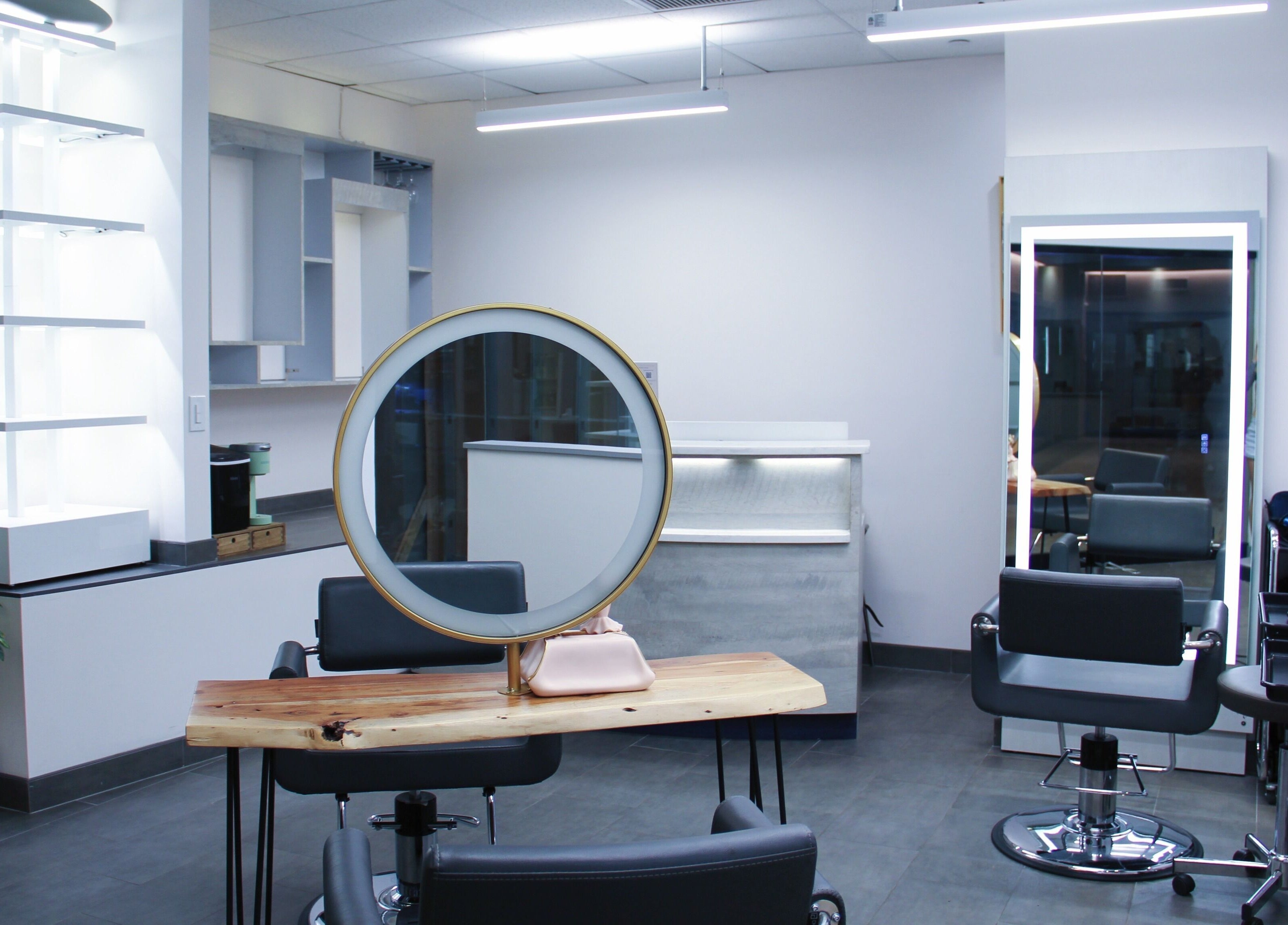 Modern salon interior with round mirror at Nova Salon in New York, New York, US.
