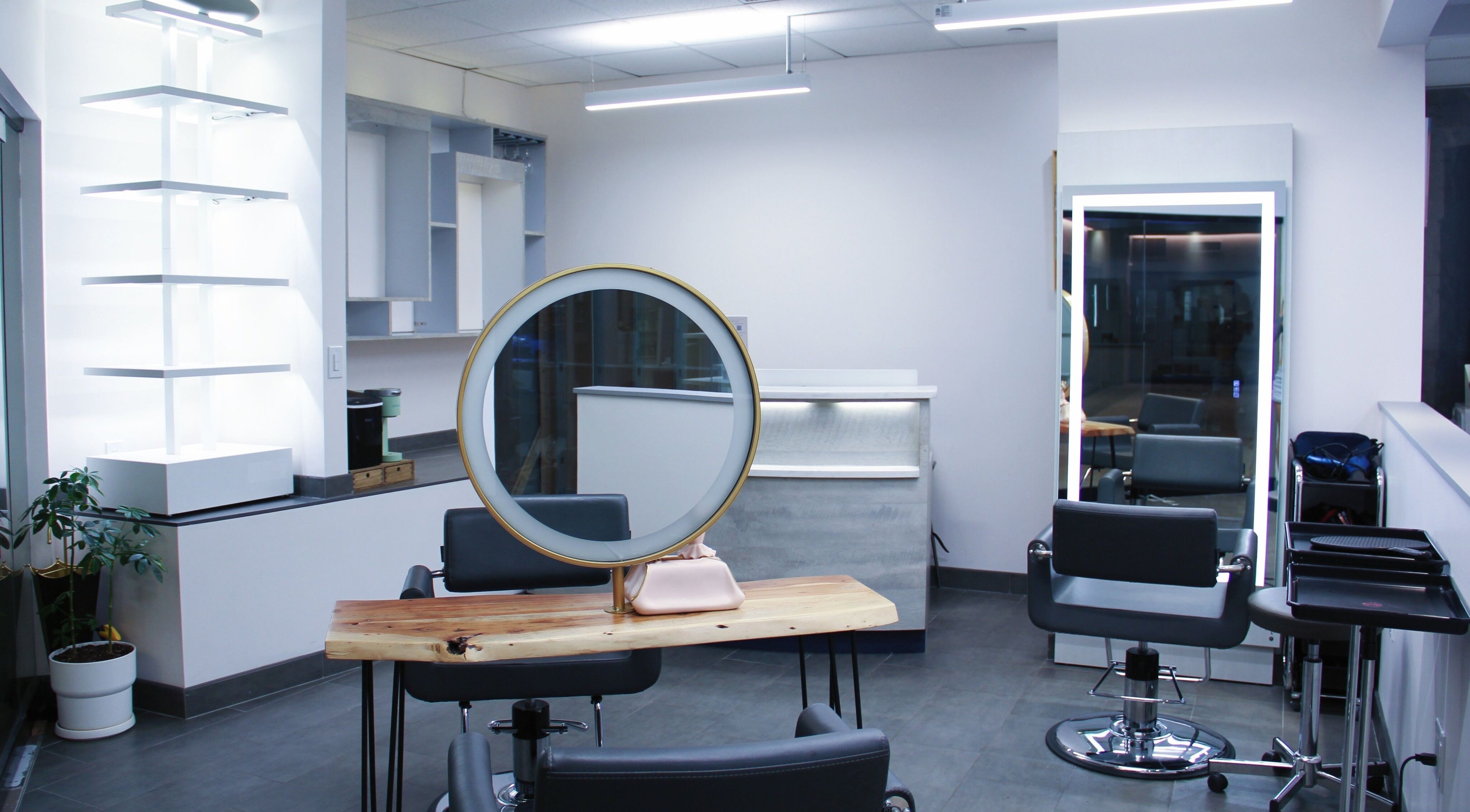 Modern salon interior with round mirror at Nova Salon in New York, New York, US.