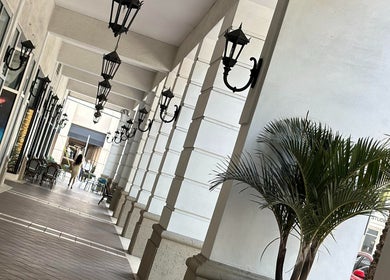 Elegant corridor at Maro Wellness Center Miami, Coral Gables, Florida, US, with stylish lamps and lush plants.