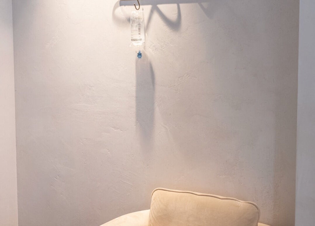 Minimalist lounge area at Rewind, Currumbin Waters, Queensland, AU with a soft beige couch.